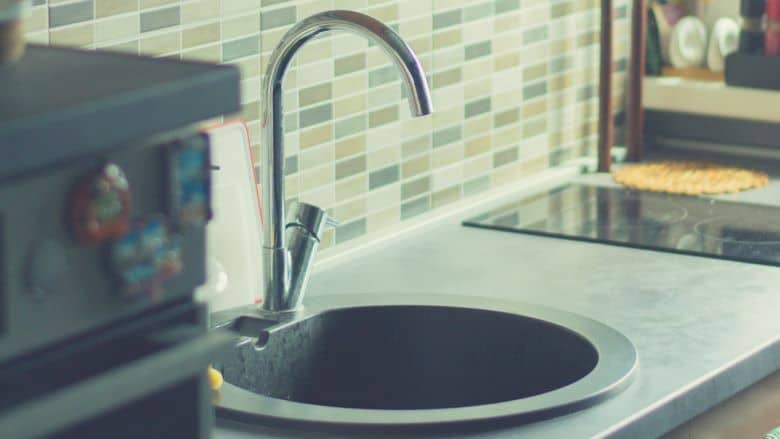 a kitchen sink with a gooseneck faucet